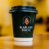 A steaming cup of Karak Chai, a strong and flavorful tea brewed with milk, sugar, and aromatic spices.